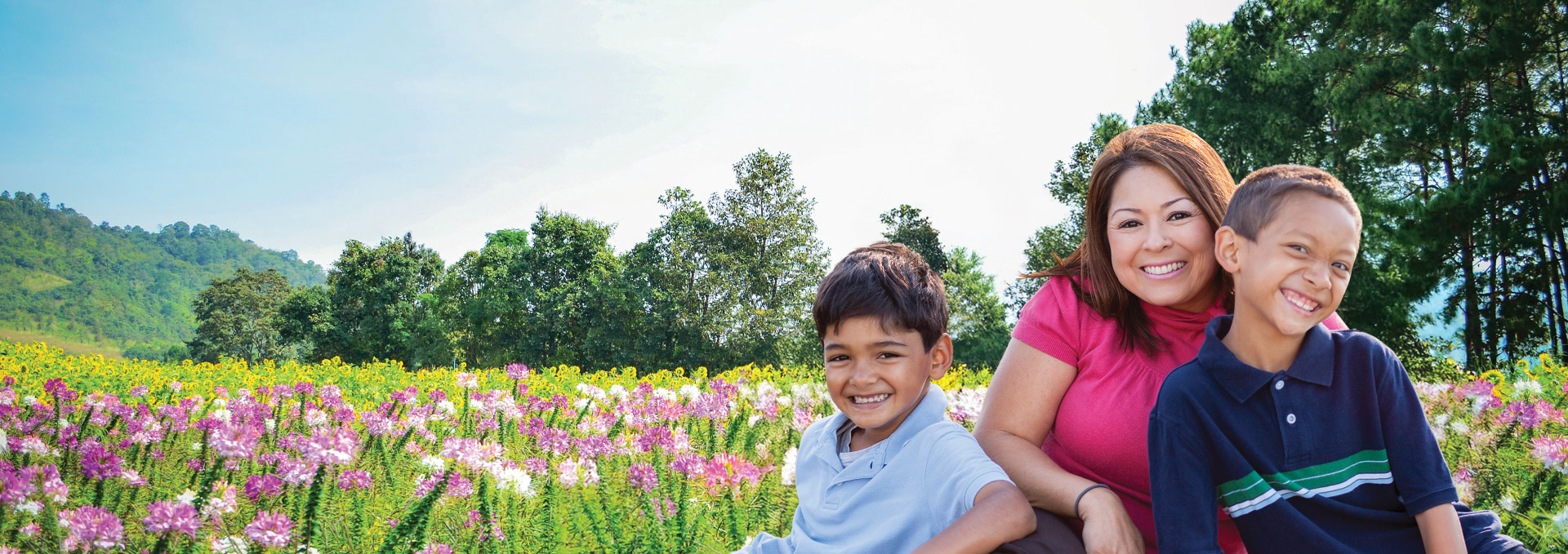 Bancroft Dental Care family after teeth cleaning in a field of flowers San Leandro CA