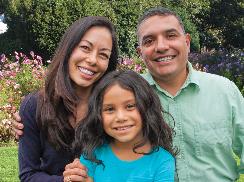 Family smiling in a garden Bancroft Dental Care San Leandro CA